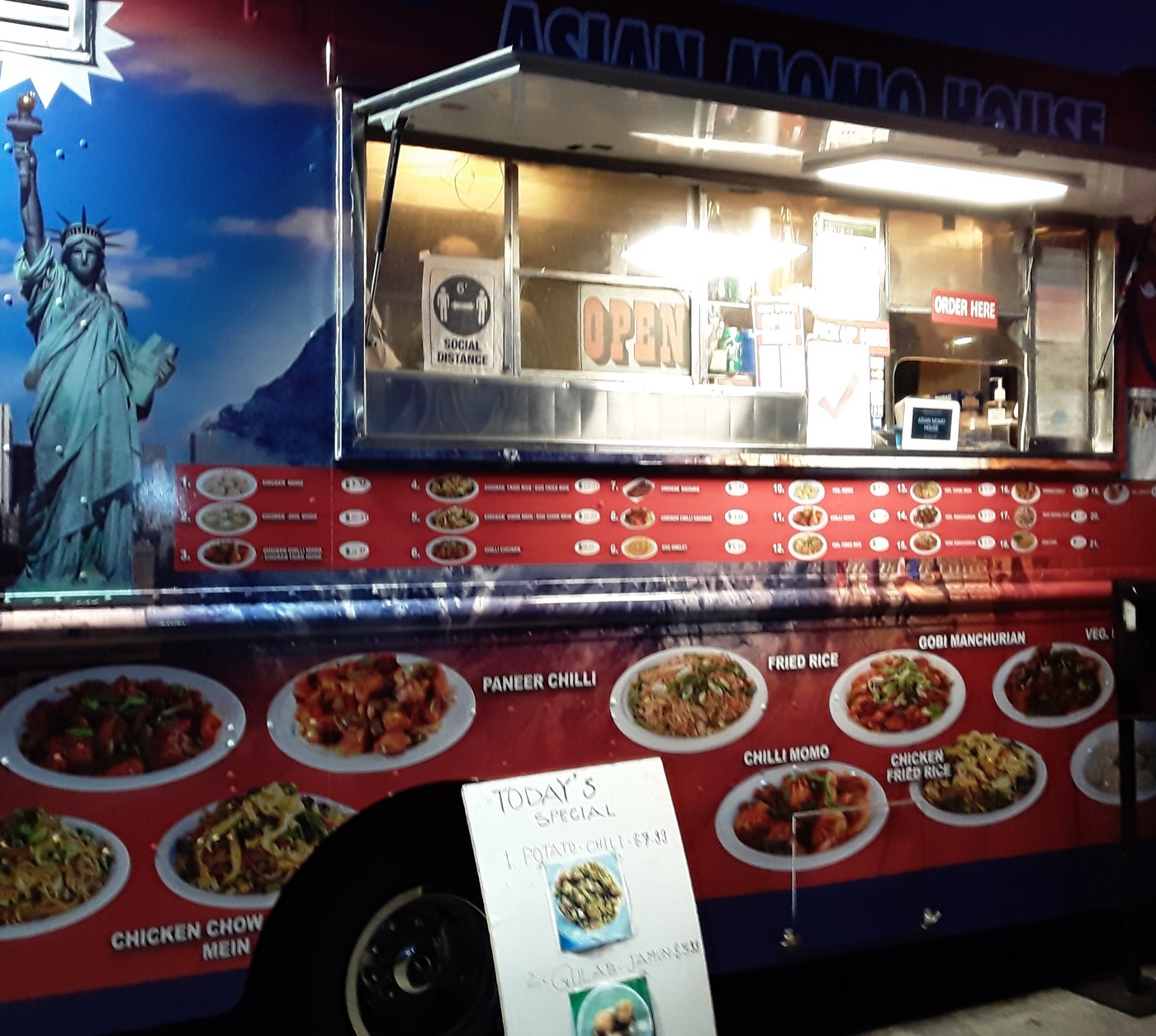 The Asian Momo House food truck at night with its service window lit up